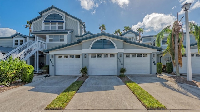 1328 Siesta Bayside Dr Unit 1328-C, Sarasota, FL 34242 - view of front of property with concrete driveway, stucco siding, and a garage