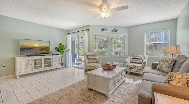 tiled living room featuring a wealth of natural light, a textured ceiling, and ceiling fan