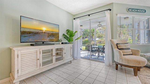 1328 Siesta Bayside Dr Unit 1328-C, Sarasota, FL 34242 - living area with a textured ceiling and baseboards
