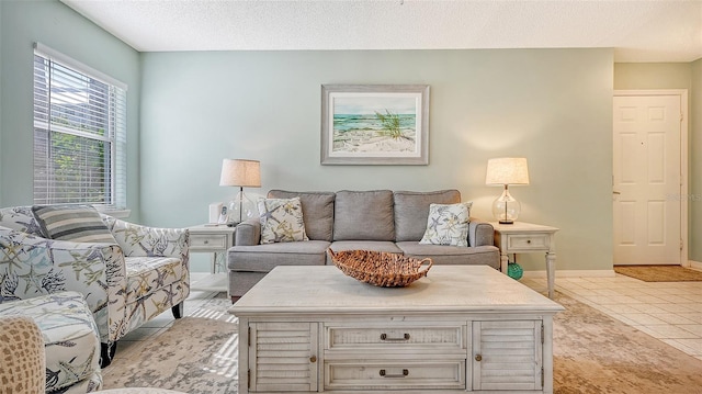 living room featuring light tile patterned flooring and a textured ceiling