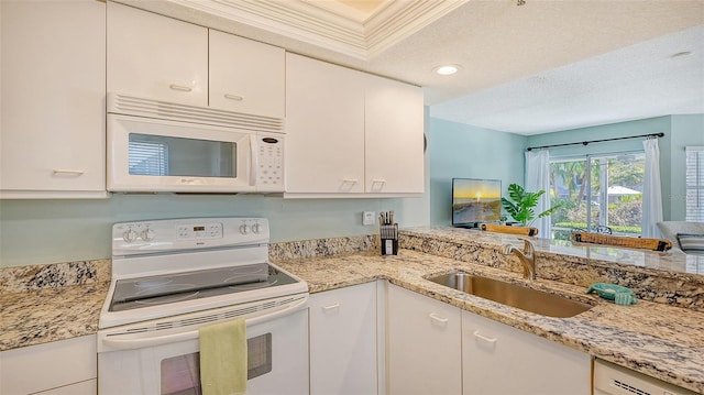 kitchen featuring a textured ceiling, sink, white appliances, and white cabinets