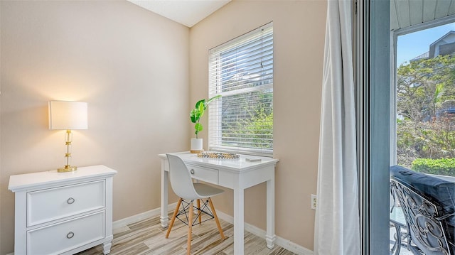 office area with a wealth of natural light and light hardwood / wood-style floors