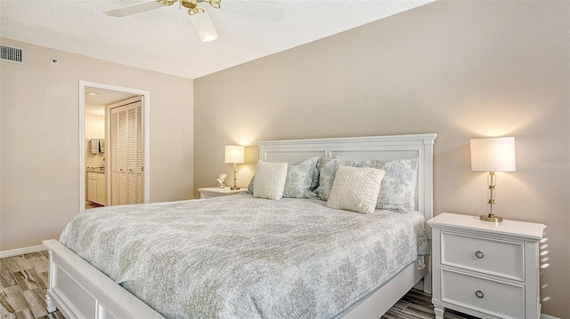 bedroom featuring hardwood / wood-style floors, ceiling fan, a textured ceiling, and a closet