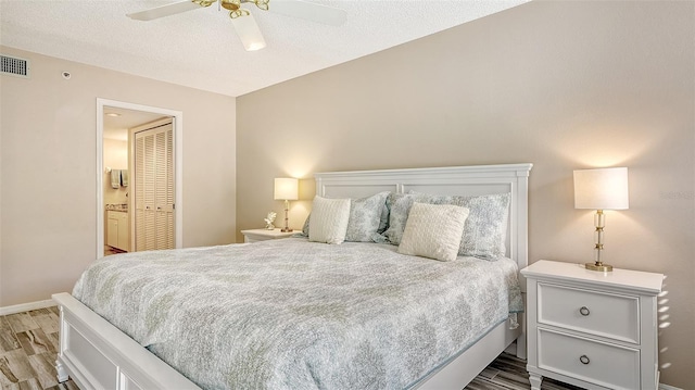 1328 Siesta Bayside Dr Unit 1328-C, Sarasota, FL 34242 - bedroom featuring wood finished floors, baseboards, ceiling fan, and a textured ceiling