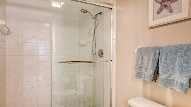 bathroom with walk in shower and toilet