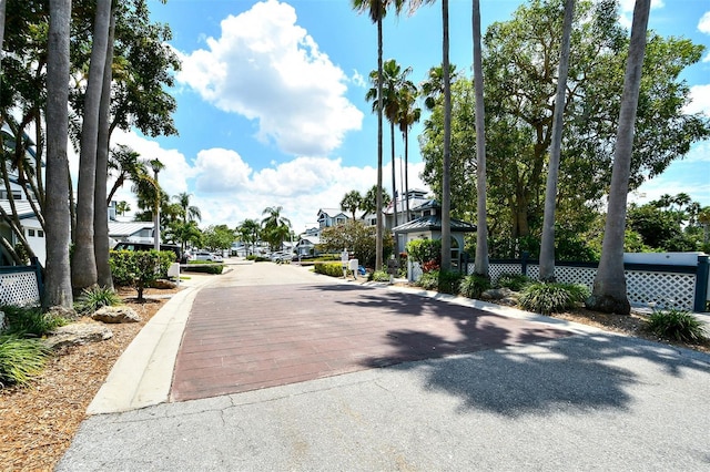 1328 Siesta Bayside Dr Unit 1328-C, Sarasota, FL 34242 - view of asphalt road featuring a residential view and curbs