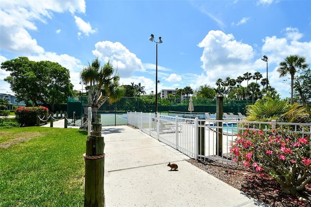 1328 Siesta Bayside Dr Unit 1328-C, Sarasota, FL 34242 - view of property's community featuring a gate and a tennis court