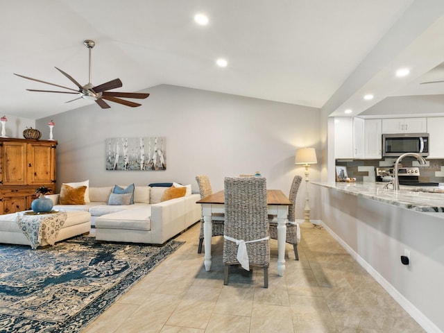 living room featuring light tile patterned flooring, lofted ceiling, and ceiling fan