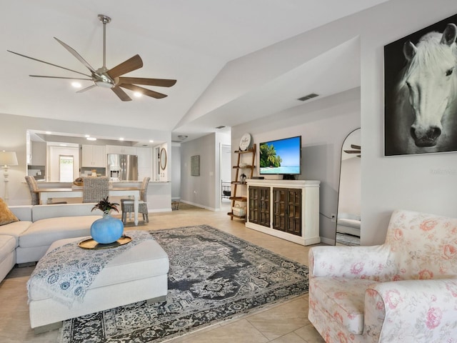 living room with lofted ceiling, light tile patterned floors, and ceiling fan