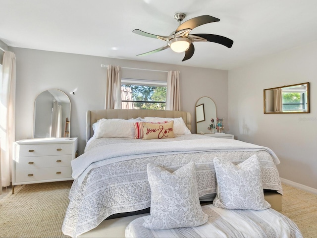 bedroom featuring light colored carpet and ceiling fan