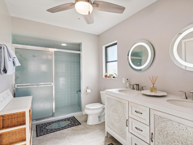 bathroom featuring vanity, an enclosed shower, tile patterned flooring, toilet, and ceiling fan