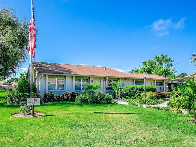 ranch-style house featuring a front lawn