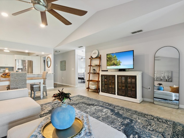 tiled living room with ceiling fan and vaulted ceiling