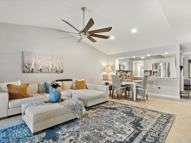 living room with ceiling fan, vaulted ceiling, and light tile patterned flooring