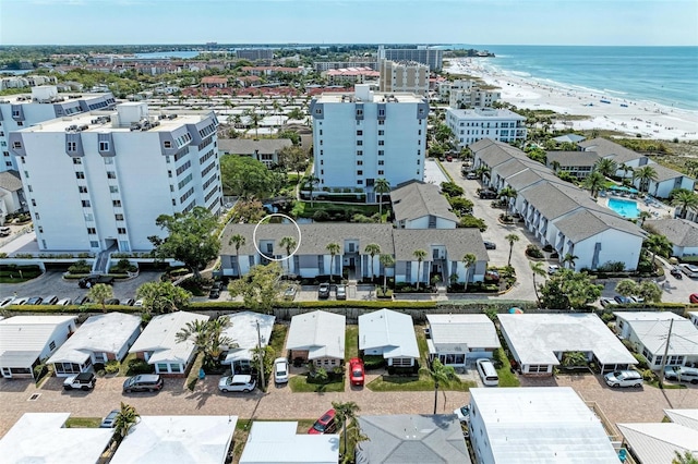 drone / aerial view featuring a water view and a beach view