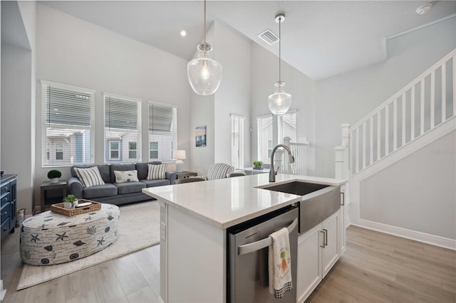 kitchen with dishwasher, a healthy amount of sunlight, white cabinets, and sink