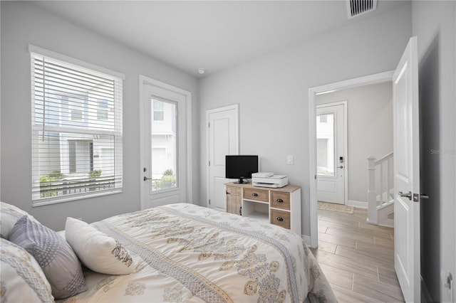 bedroom featuring multiple windows and light hardwood / wood-style floors