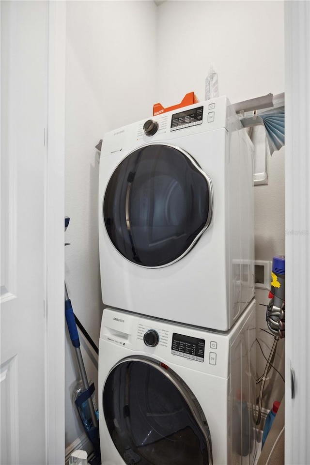 laundry room with stacked washer and clothes dryer