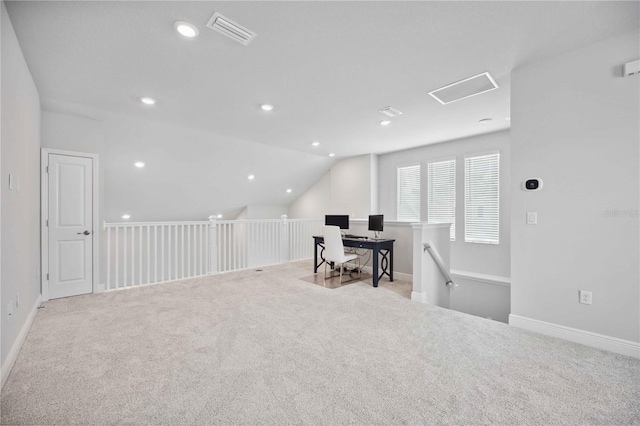 home office featuring vaulted ceiling and light carpet