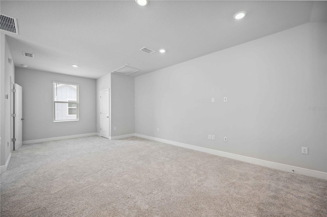 unfurnished room featuring light carpet