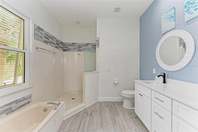 full bathroom with hardwood / wood-style flooring, toilet, separate shower and tub, and vanity