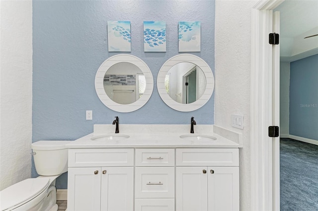 bathroom featuring toilet and vanity