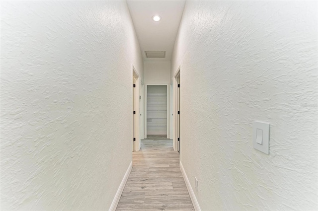 corridor with light wood-type flooring