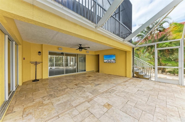 view of patio with a balcony and ceiling fan