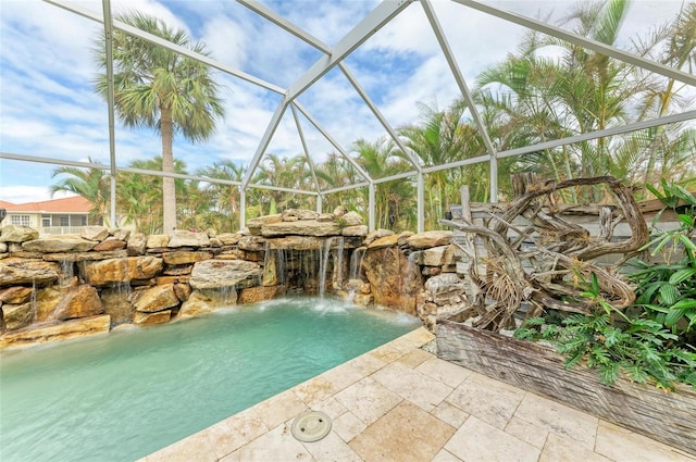 view of swimming pool with pool water feature, a lanai, and a patio