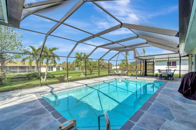 view of pool with a patio area and a lanai