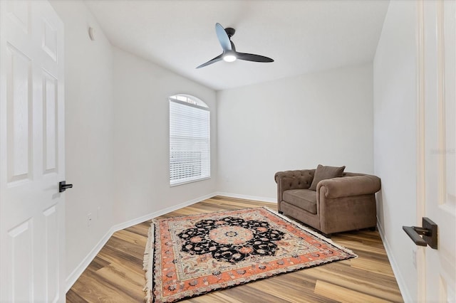 sitting room with hardwood / wood-style floors and ceiling fan