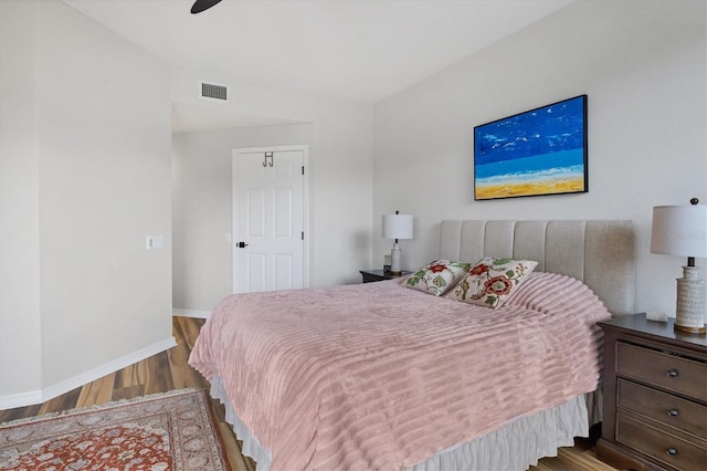 bedroom with hardwood / wood-style floors and ceiling fan