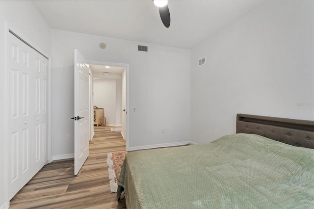 unfurnished bedroom with a closet, wood-type flooring, and ceiling fan