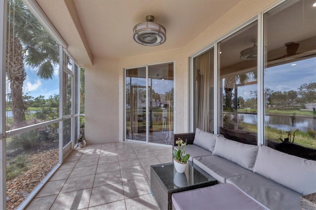 sunroom / solarium with plenty of natural light and a water view