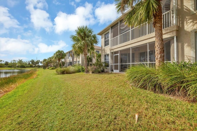 exterior space featuring a sunroom and a water view