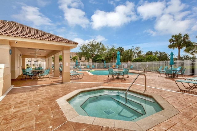 view of pool featuring a community hot tub, ceiling fan, and a patio