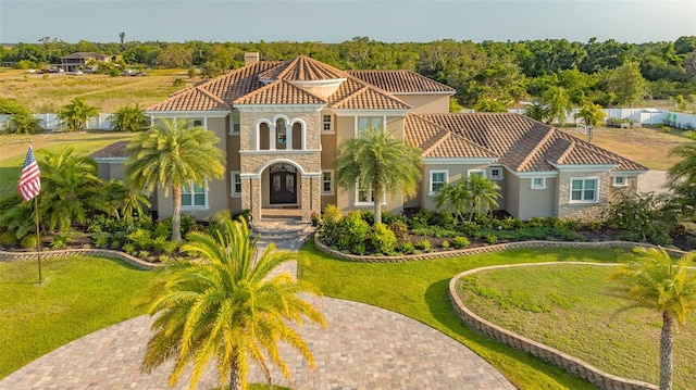 mediterranean / spanish-style house with a front yard