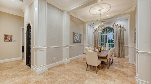 dining area featuring a notable chandelier and ornamental molding