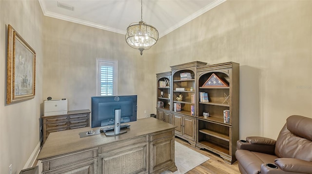 office with an inviting chandelier, a towering ceiling, light hardwood / wood-style flooring, and ornamental molding