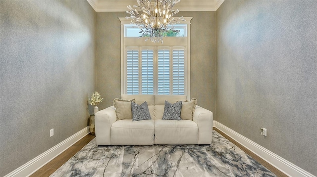 living area with ornamental molding, hardwood / wood-style floors, and a chandelier