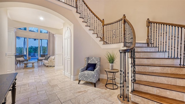 stairs featuring a towering ceiling