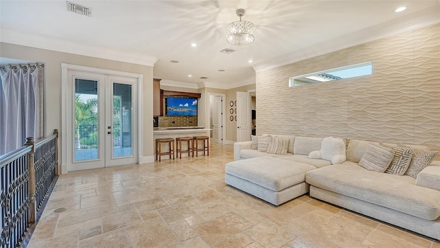 living room featuring an inviting chandelier, french doors, and crown molding