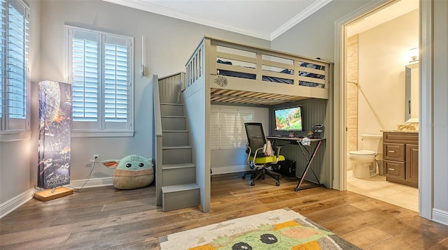 bedroom featuring multiple windows, wood-type flooring, and crown molding