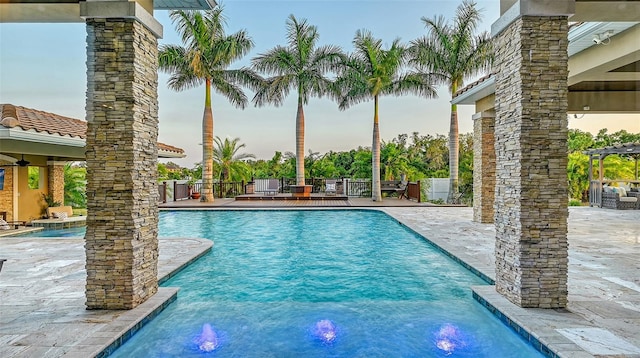 view of pool with pool water feature and a patio area