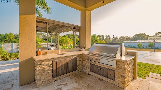 view of patio / terrace with exterior kitchen, sink, and a grill