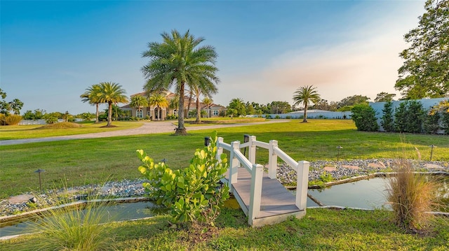 exterior space with a water view and a lawn