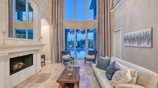 living room with plenty of natural light and a high ceiling