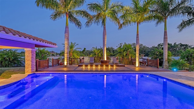 view of pool at dusk