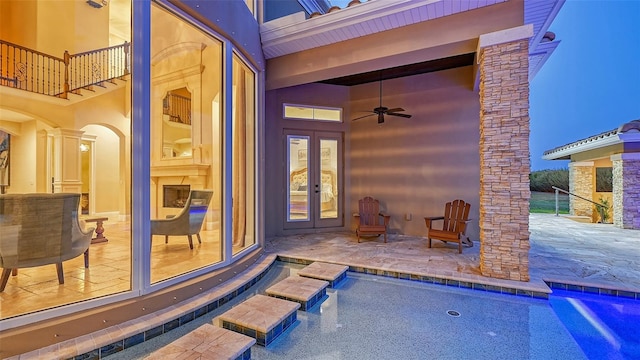 view of swimming pool with a patio area, french doors, and ceiling fan