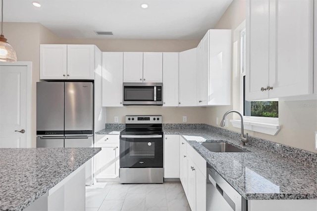 2814 Daphne Rd, North Port, FL 34288 - kitchen featuring appliances with stainless steel finishes, white cabinetry, light stone counters, light marble finish flooring, and recessed lighting